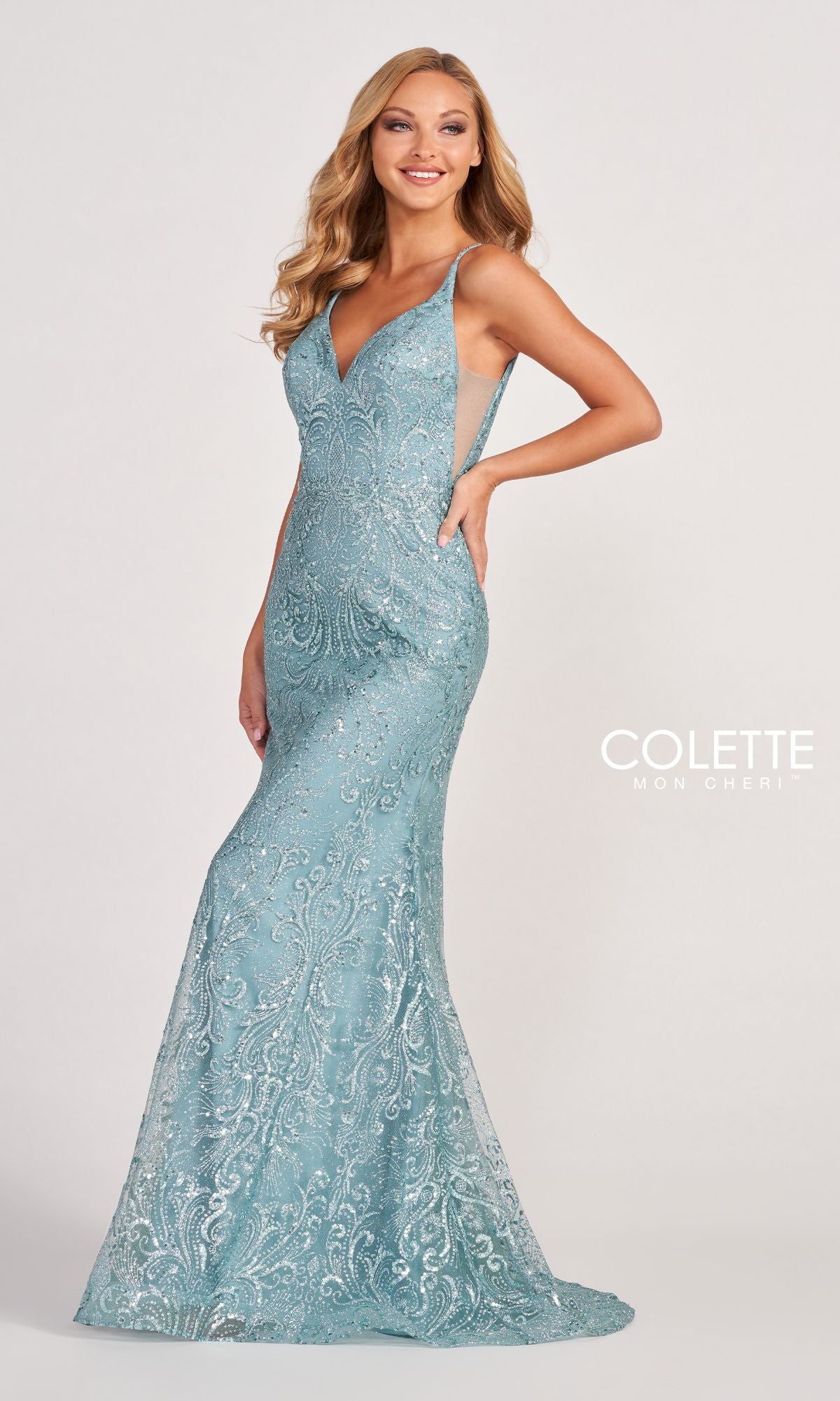 A woman models the Colette CL2019 Long Prom Dress in Glitter-Sequin, a fitted, light blue gown with a deep V-neckline. The